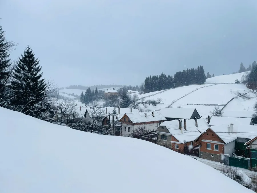 Holbav village blanketed in snow, seen from the house